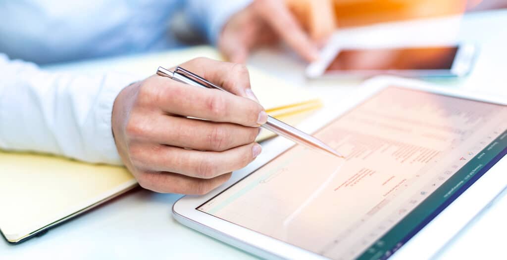close up man using digital tablet