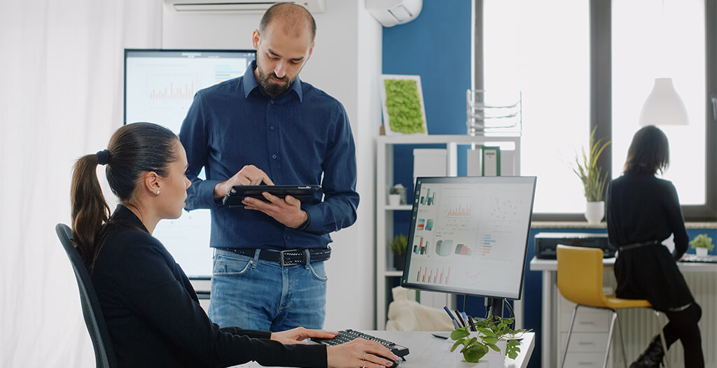 Managed Workplace Services 2 businesswoman talking man with digital tablet about project planning marketing strategy woman doing teamwork with engineer presentation design with data charts computer 2